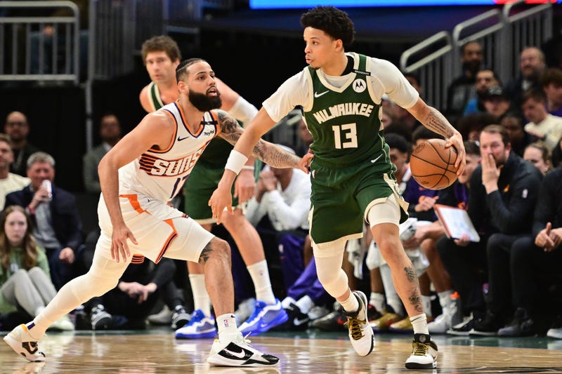 Apr 1, 2025; Milwaukee, Wisconsin, USA; Milwaukee Bucks guard Ryan Rollins (13) drives for the basket against Phoenix Suns forward Cody Martin (17) in the second quarter at Fiserv Forum. Mandatory Credit: Benny Sieu-Imagn Images