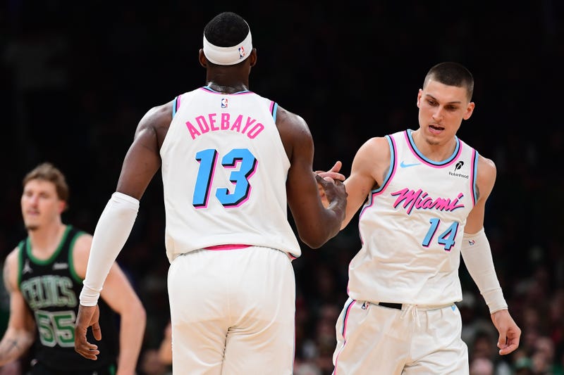 Miami Heat center Bam Adebayo (13) is congratulated by guard Tyler Herro (14) after making a basket during the second half against the Boston Celtics at TD Garden.