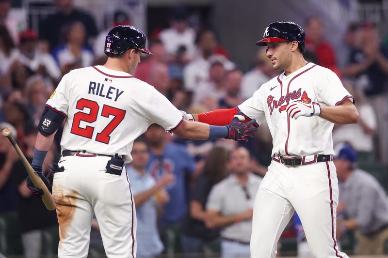 Atlanta Braves first baseman Matt Olson (28) celebrates after a home run with third baseman Austin Riley (27) against the Miami Marlins in the seventh inning at Truist Park.