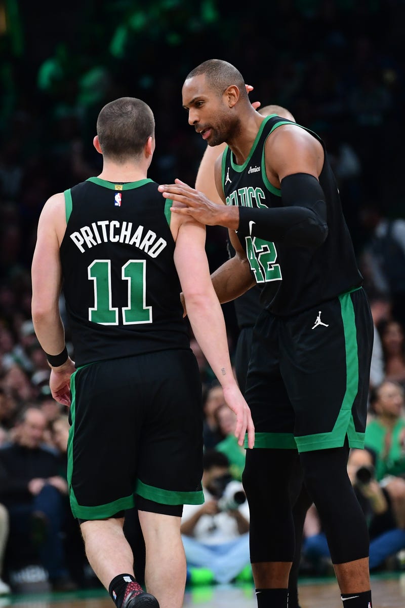 Boston Celtics center Al Horford (42) congratulates guard Payton Pritchard (11) after making a basket during the second half against the Washington Wizards at TD Garden.