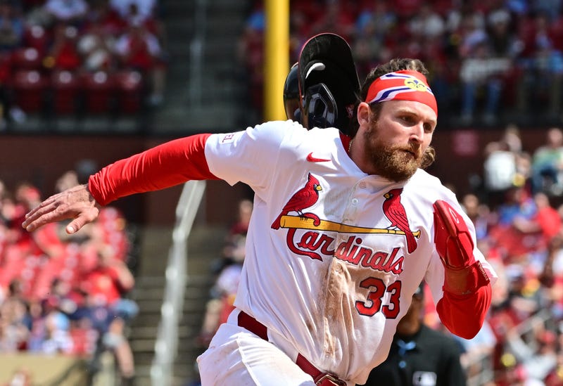  St. Louis Cardinals infielder Brendan Donovan (33) loses his batting helmet as he digs for third base against the Philadelphia Phillies at Busch Stadium.