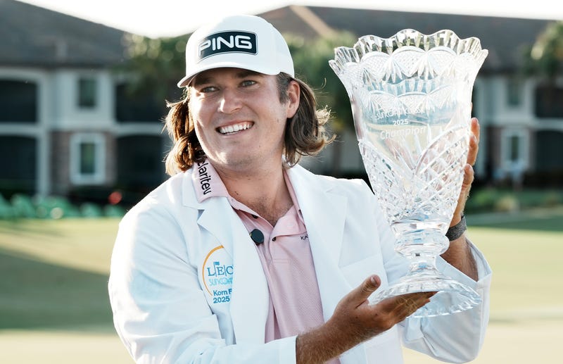Neal Shipley lifting up trophy