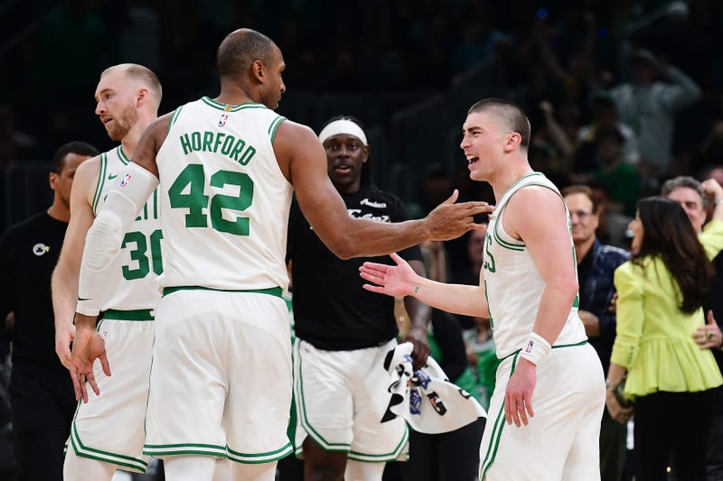 Boston Celtics guard Payton Pritchard (11) reacts with center Al Horford (42) after making a three point basket during the second half against the Orlando Magic at TD Garden.