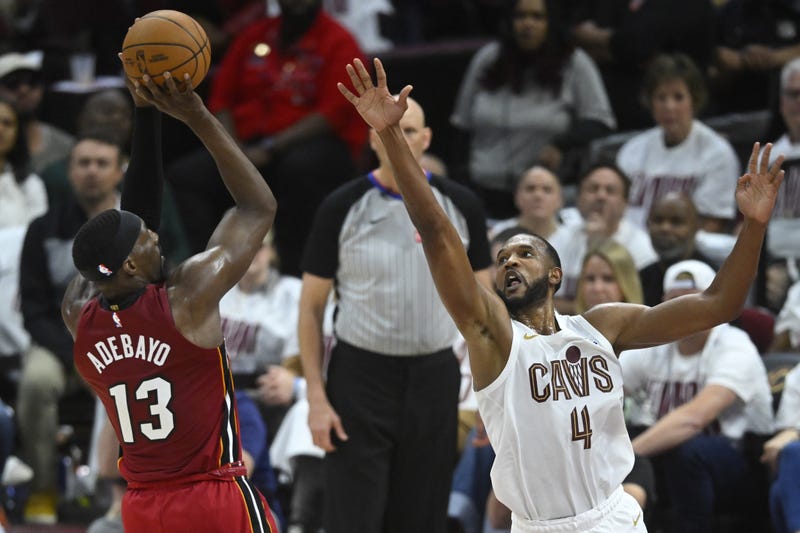 Apr 20, 2025; Cleveland, Ohio, USA; Miami Heat center Bam Adebayo (13) shoots beside Cleveland Cavaliers forward Evan Mobley (4) in the fourth quarter at Rocket Arena.