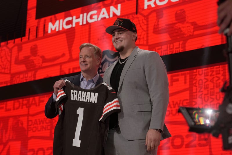 Mason Graham, DT, Michigan poses with NFL Commissioner Roger Goodell after being selected 5th overall by the Cleveland Browns during the first round of the 2025 NFL Draft at Lambeau Field on April 24, 2025 in Green Bay, Wisconsin.