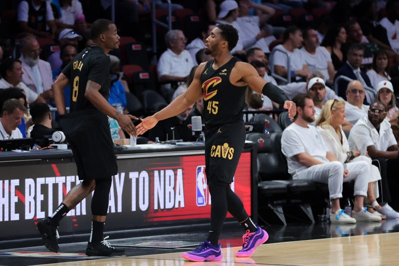 Apr 26, 2025; Miami, Florida, USA; Cleveland Cavaliers guard Donovan Mitchell (45) high-fives with guard Javonte Green (8) in the fourth quarter against the Miami Heat during game three for the first round of the 2025 NBA Playoffs at Kaseya Center.