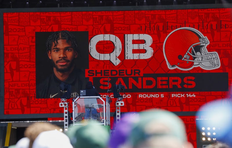 Apr 25, 2025; Green Bay, WI, USA; A graphic announcing Colorado quarterback Shedeur Sanders’ selection by the Cleveland Browns with the 144th overall pick is seen in the Draft Theater during the third day of the 2025 NFL Draft at Lambeau Field.