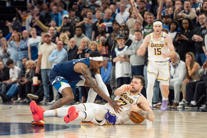 Los Angeles Lakers guard Luka Doncic (77) calls a timeout after stumbling on the defense of Minnesota Timberwolves forward Jaden McDaniels (3) in the fourth quarter during game four of first round for the 2025 NBA Playoffs at Target Center. The NBA after the game said it should have been called a foul on McDaniels.