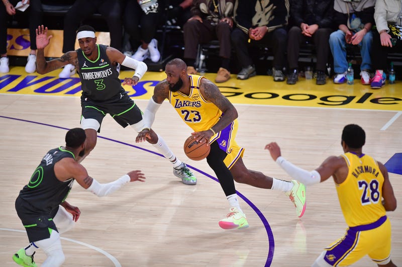 Los Angeles Lakers forward LeBron James (23) moves to the basket against Minnesota Timberwolves forward Jaden McDaniels (3) and guard Mike Conley (10) during the second half in game five of first round for the 2025 NBA Playoffs at Crypto.com Arena.