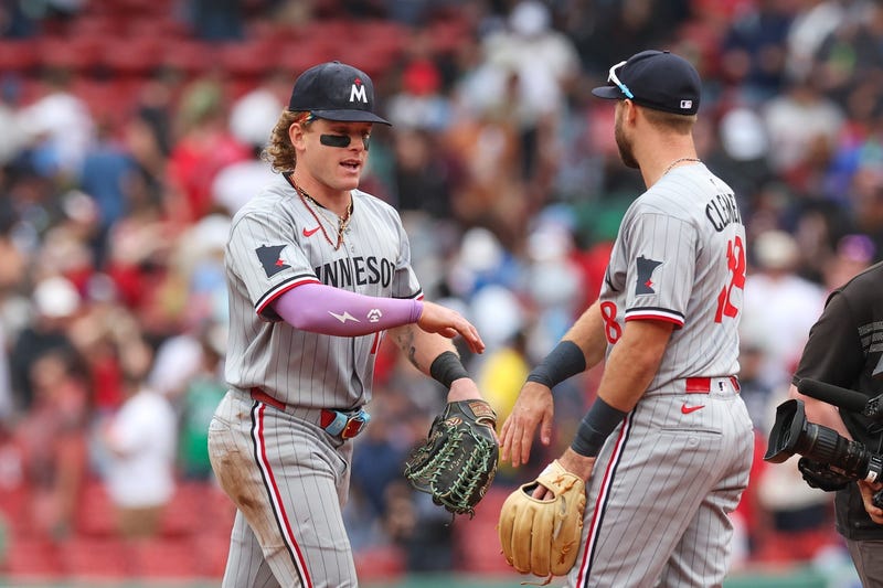 Minnesota Twins right fielder Harrison Bader (12) high fives Minnesota Twins second baseman Kody Clemens (18) after defeating the Boston Red Sox at Fenway Park.