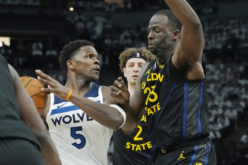 Minnesota Timberwolves guard Anthony Edwards (5) controls the ball against Golden State Warriors forward Draymond Green (23) in the first quarter during game one of the second round for the 2025 NBA Playoffs at Target Center.
