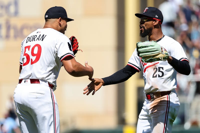 Twins pitcher Jhoan Duran (59) and center fielder Byron Buxton (25) celebrate their teams win against the Baltimore Orioles after the game at Target Field.