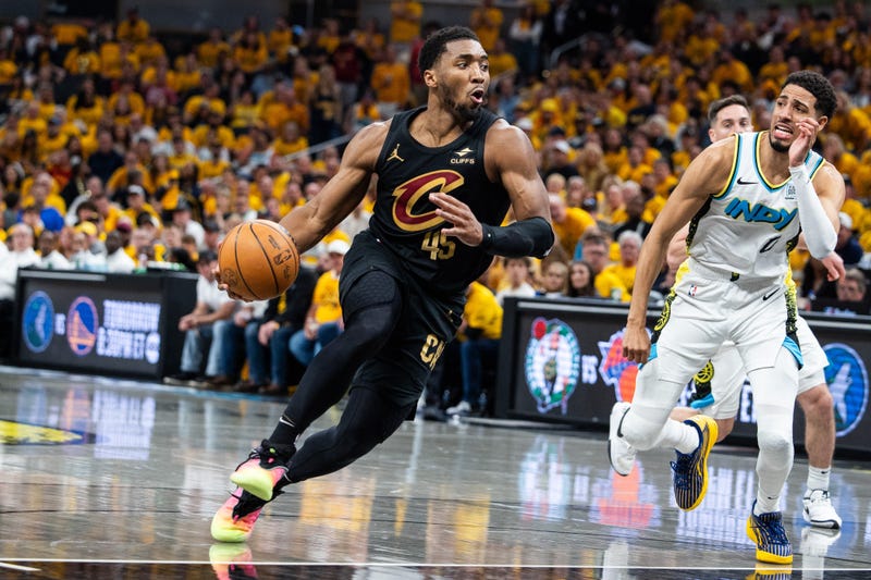 Cleveland Cavaliers guard Donovan Mitchell (45) dribbles the ball while Indiana Pacers guard Tyrese Haliburton (0) defends during game three of the second round for the 2025 NBA Playoffs at Gainbridge Fieldhouse.
