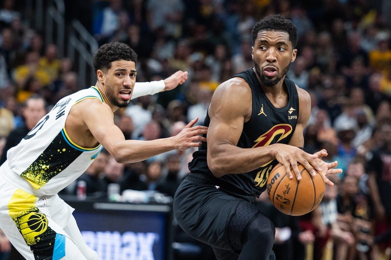 May 11, 2025; Indianapolis, Indiana, USA; Cleveland Cavaliers guard Donovan Mitchell (45) dribbles the ball while Indiana Pacers guard Tyrese Haliburton (0) defends during game four of the second round for the 2025 NBA Playoffs at Gainbridge Fieldhouse. 