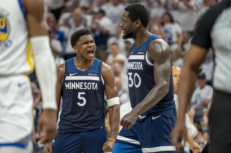 Minnesota Timberwolves guard Anthony Edwards (5) celebrates with Minnesota Timberwolves forward Julius Randle (30) after making a shot against the Golden State Warriors in the first half during game five of the second round for the 2025 NBA Playoffs at Target Center.