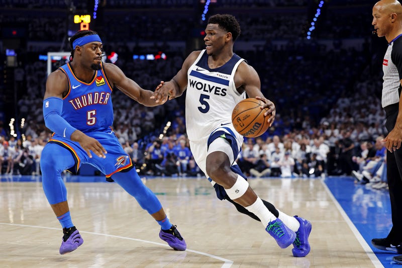 Timberwolves guard Anthony Edwards (5) drives to the basket against Oklahoma City Thunder guard Luguentz Dort (5) during the second quarter in game five of the western conference finals for the 2025 NBA Playoffs at Paycom Center. 