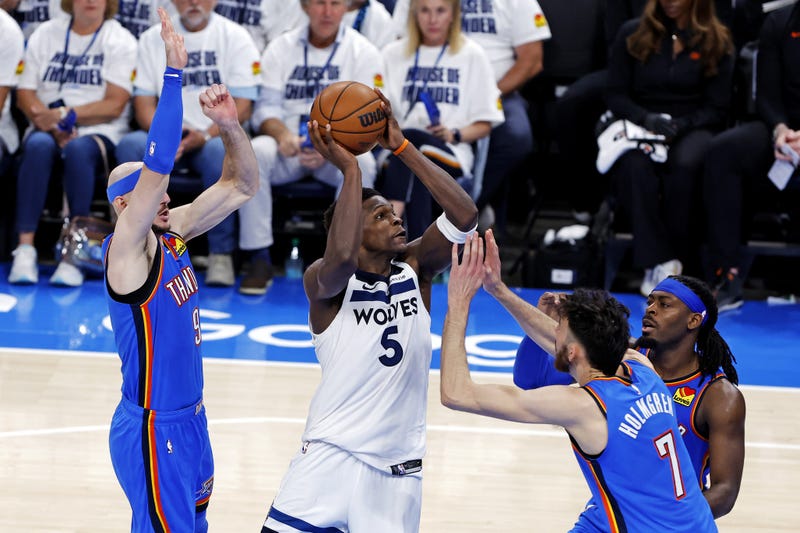 Minnesota Timberwolves guard Anthony Edwards (5) drives to the basket against Oklahoma City Thunder guard Alex Caruso (9) during the third quarter in game five of the western conference finals for the 2025 NBA Playoffs at Paycom Center. 