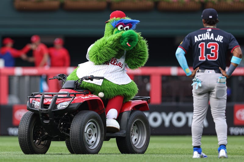 The Phillie Phanatic reacts with Atlanta Braves outfielder Ronald Acuña Jr. (13) before action at Citizens Bank Park.