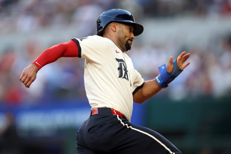 Texas Rangers second base Marcus Semien (2) scores a run during the second inning against the St. Louis Cardinals at Globe Life Field.