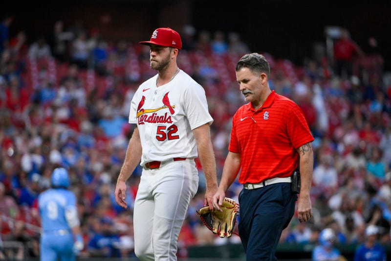 St. Louis Cardinals starting pitcher Matthew Liberatore (52) walks off the field with a trainer after he was removed from the game with an injury during the fifth inning against the Kansas City Royals at Busch Stadium.