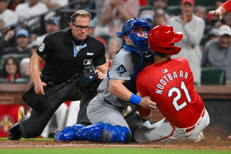 St. Louis Cardinals left fielder Lars Nootbaar (21) collides with Los Angeles Dodgers catcher Dalton Rushing (68) as he slides safely in at home to score during the fifth inning at Busch Stadium.