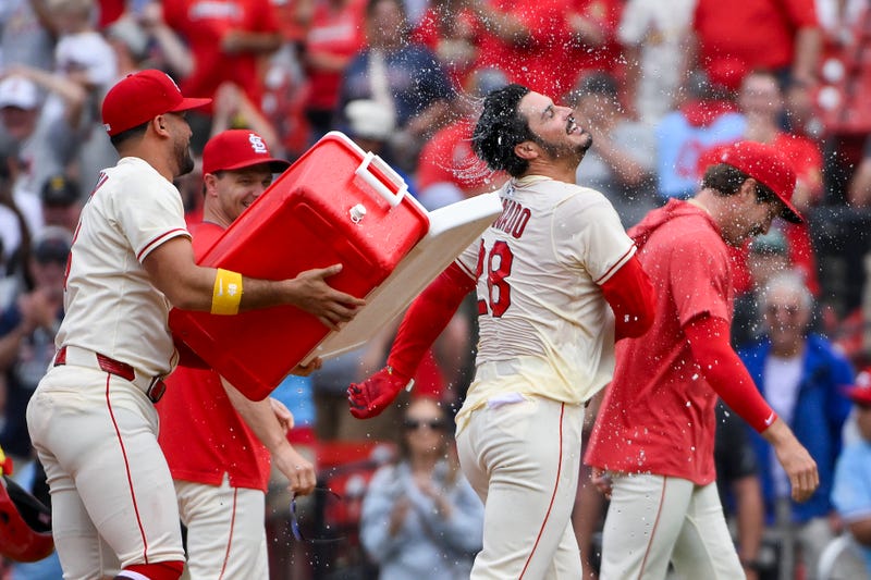  St. Louis Cardinals pinch hitter Nolan Arenado (28) is doused with water and mobbed by teammates after hitting a walk-off one run single against the Los Angeles Dodgers during the ninth inning at Busch Stadium.