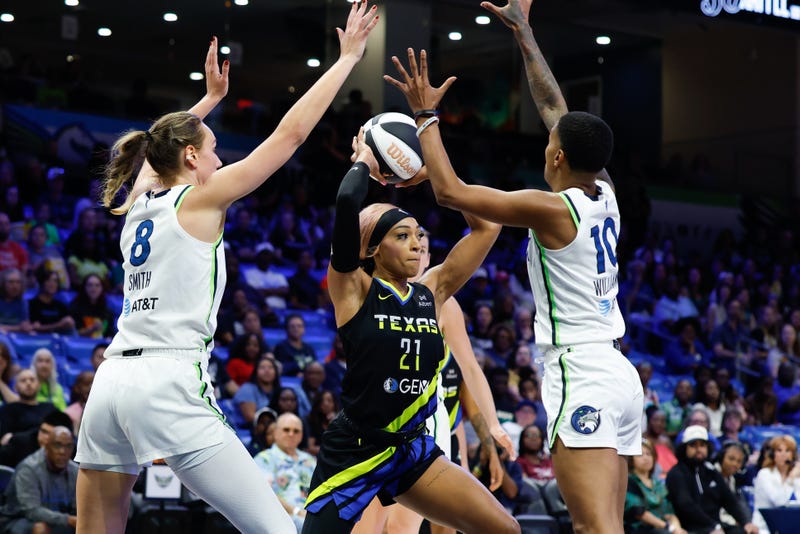 DiJonai Carrington (21) - now a player for the Minnesota Lyx - looks to pass between Lynx forward Alanna Smith (8) and guard Courtney Williams (10) during a game in Dallas back in June.