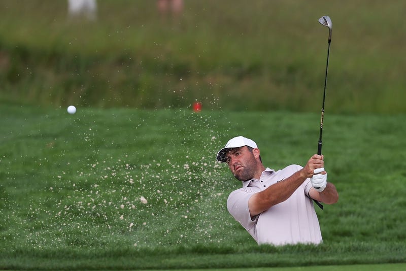 Scottie Scheffler hitting out of a bunker