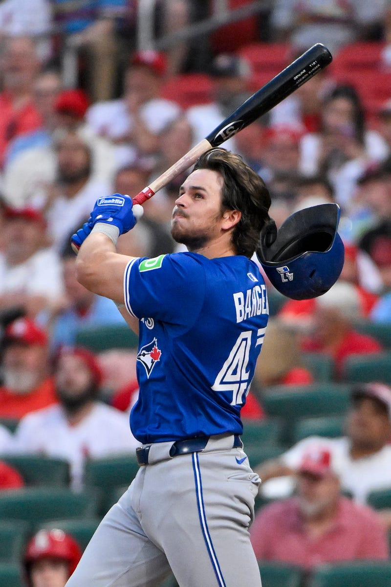 Toronto Blue Jays third baseman Addison Barger (47) loses his helmet as he hits a one run double against the St. Louis Cardinals during the fifth inning at Busch Stadium.
