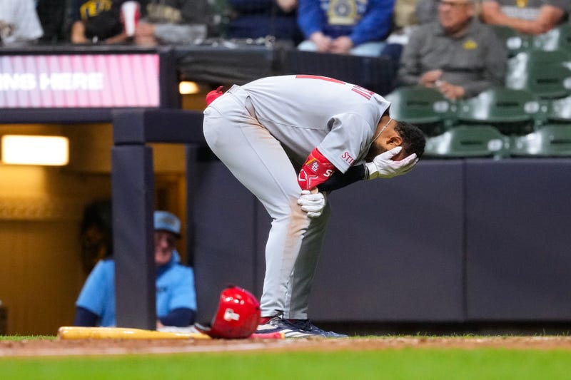 St. Louis Cardinals center fielder Victor Scott II (11) reacts after being hit in the helmet by a pitch during the eighth inning against the Milwaukee Brewers at American Family Field.