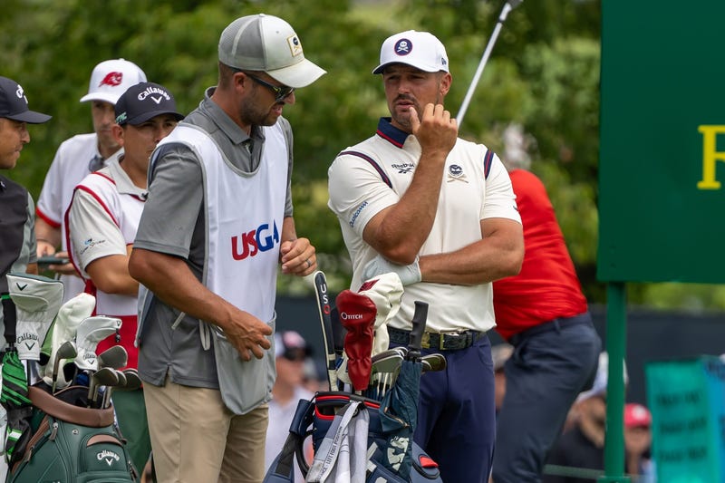 Bryson DeChambeau questioning caddy