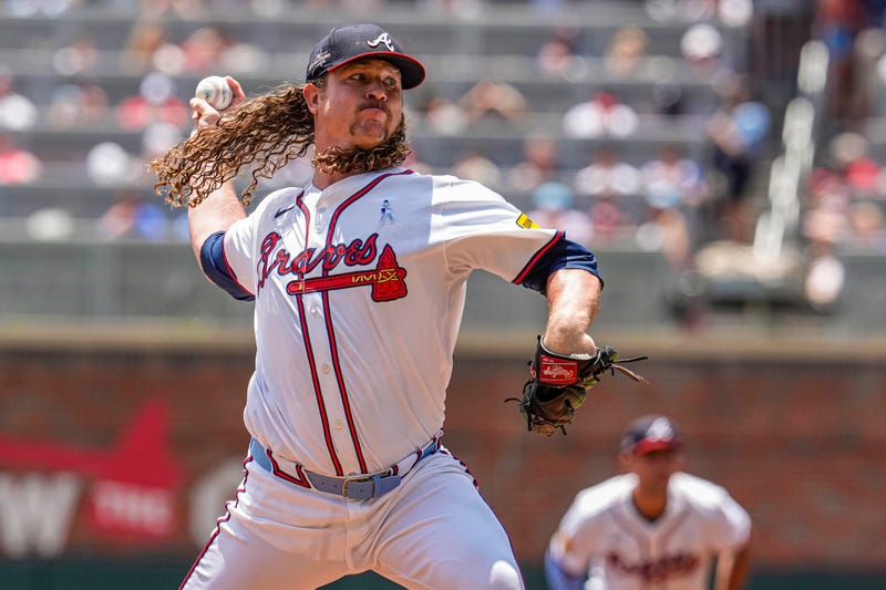 Atlanta Braves starting pitcher Grant Holmes (66) pitches against the Colorado Rockies during the first inning at Truist Park.