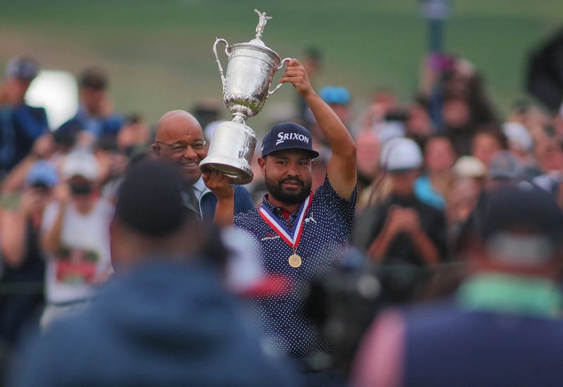 J.J. Spaun hoists his trophy in the air while celebrating his US Open Championship win at Oakmont Country Club in Oakmont, PA on June 15, 2025.