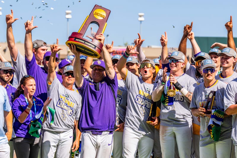 LSU Tigers head coach Jay Johnson hoists the trophy after winning the College World Series