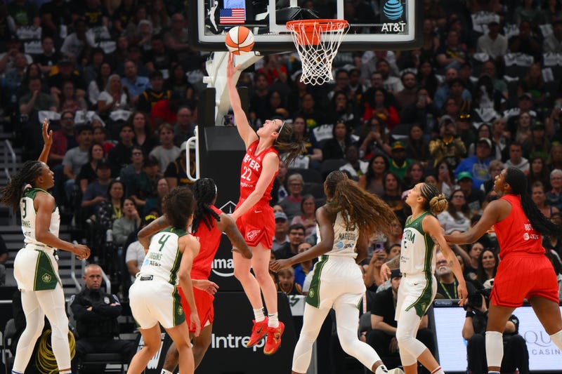 Indiana Fever guard Caitlin Clark (22) shoots the ball against the Seattle Storm during the first half at Climate Pledge Arena. 