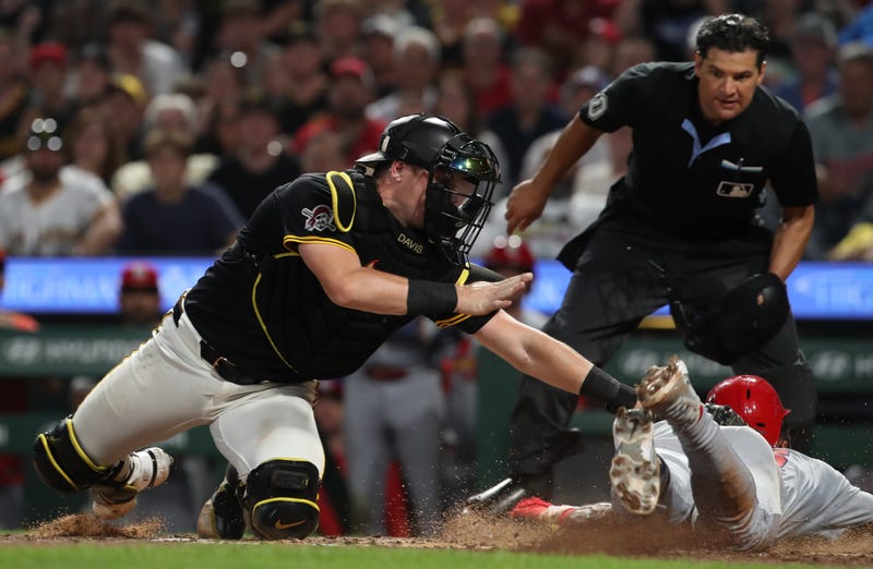 Pittsburgh Pirates catcher Henry Davis (32) tags St. Louis Cardinals designated hitter Jose Fermin (right) out at home plate attempting to score during the ninth inning at PNC Park.