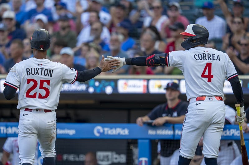 Now former Minnesota Twins teammates, center fielder Byron Buxton (25) shakes hands with shortstop Carlos Correa (4). With Correa gone, will the Twins look for other ways to trim payroll in the offseason, and could that include Buxton?