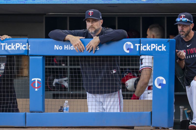 Now former Minnesota Twins manager Rocco Baldelli (5) looks on from the dugout at Target Field - the Twins are now deep into the search for the next person who will take on the role of the team's skipper.