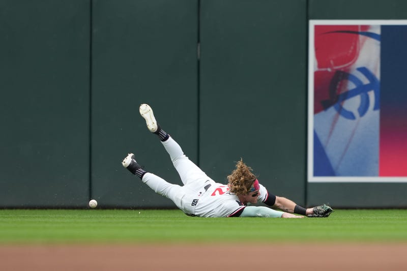 Twins center fielder Harrison Bader (12) attempts to field the ball during the first inning against the Chicago Cubs at Target Field.  