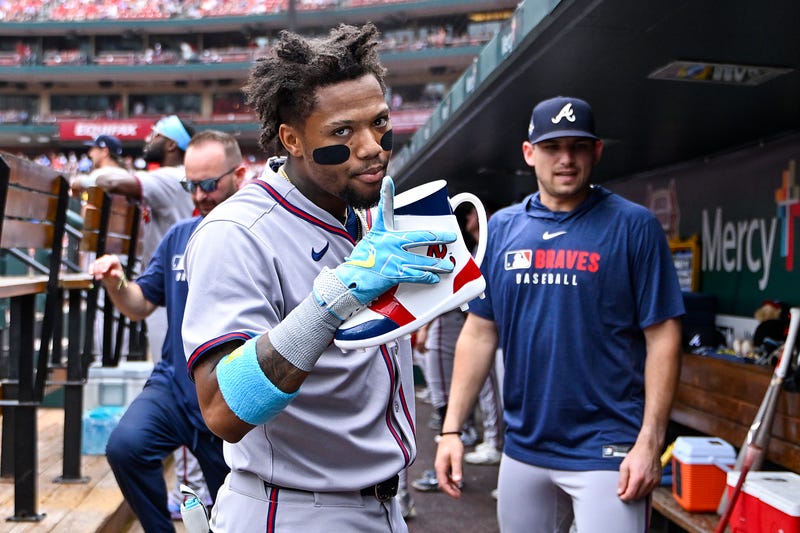 Atlanta Braves right fielder Ronald Acuna Jr (13) celebrates in the dugout after hitting a solo home run against the St. Louis Cardinals during the first inning at Busch Stadium