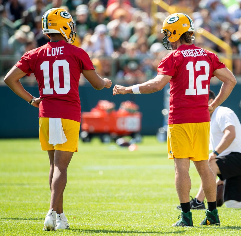 Green Bay Packers quarterback Jordan Love (10) and quarterback Aaron Rodgers (12) fist bump during the third day of training camp Friday, July 30, 2021 in Green Bay, Wisconsin. Love was Rodgers' backup for three seasons (2020-22).