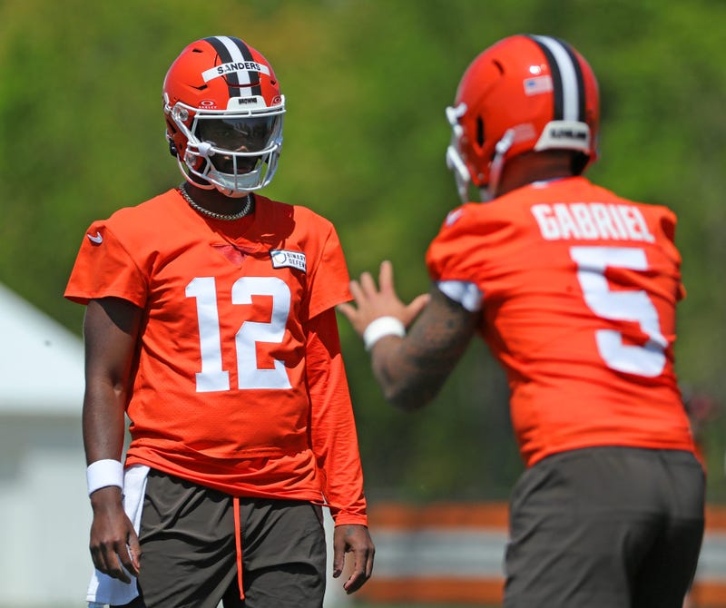 Cleveland Browns quarterback Shedeur Sanders (12) watches quarterback Dillon Gabriel (5) during day two of rookie minicamp May 10, 2025, in Berea, Ohio.
