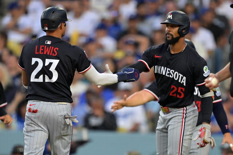 Minnesota Twins third base Royce Lewis (23) and outfielder Byron Buxton (25) react after scoring against the Los Angeles Dodgers in the first inning at Dodger Stadium. After a flurry of trades gutted much of the Twins roster, these two are going to have to lead a very young core of players.