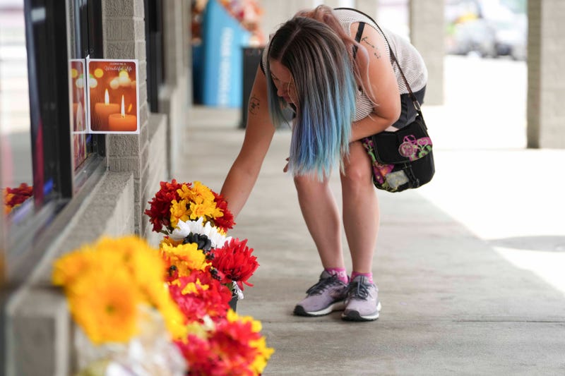 Whitney Montgomery places flowers at the closed Hulk Hogan's Wrestling Shop in Pigeon Forge, Tenn., at 147 East Wears Valley Road on July 24, 2024. Hulk Hogan's death was announced on July 24.