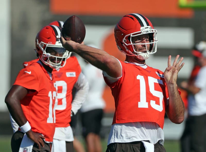 Cleveland Browns quarterback Joe Flacco (15) throws as quarterback Shedeur Sanders (12) looks on during a training camp practice July 23, 2025, in Berea, Ohio.
