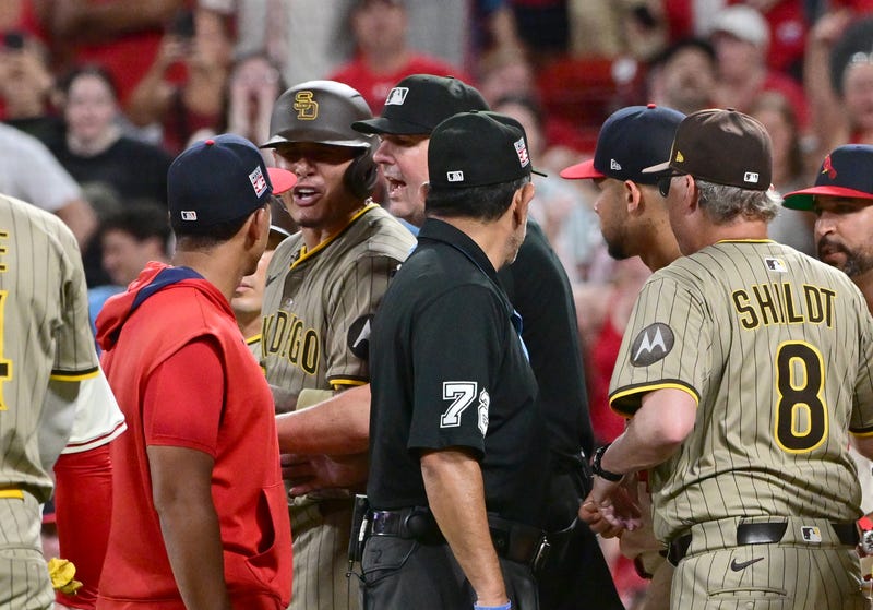 St. Louis Cardinals coach Jon Jay (19, left) and San Diego Padres third baseman Manny Machado (13) exchange words as officials try to calm things down after benches cleared in the ninth inning at Busch Stadium.
