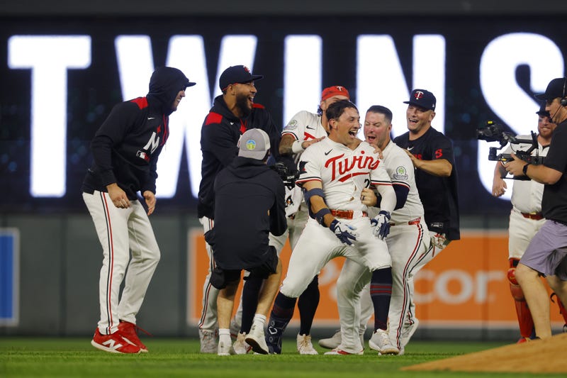 Minnesota Twins second baseman Brooks Lee (2) celebrates with his teammates his walk-off two run single against the Boston Red Sox in the ninth inning at Target Field. 