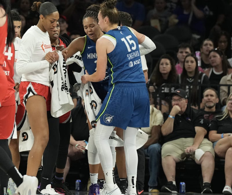 Players from the Las Vegas Aces and Minnesota Lynx surround Lynx forward Napheesa Collier (24) after she does down with an injury in the third quarter of their game at Michelob Ultra Arena. 
