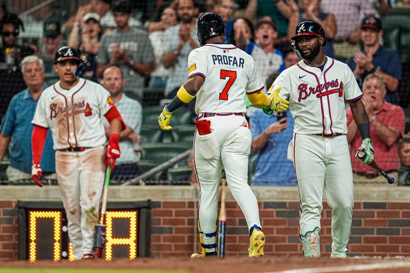 Atlanta Braves outfielder Jurickson Profar (7) reacts with outfielder Michael Harris II (23) after hitting a home run against the Milwaukee Brewers during the sixth inning at Truist Park