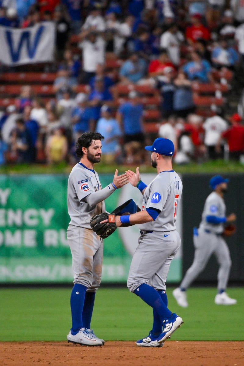 Chicago Cubs shortstop Dansby Swanson (7) celebrates with second baseman Jon Berti (5) after the Cubs defeated the St. Louis Cardinals at Busch Stadium.
